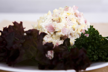Beautiful tasty salad with lots of gradients on the table red onion greens