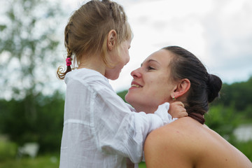 Fototapeta premium Portrait of mother and daughter outdoors forest river grass