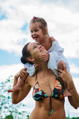 Portrait of mother and daughter outdoors forest river grass