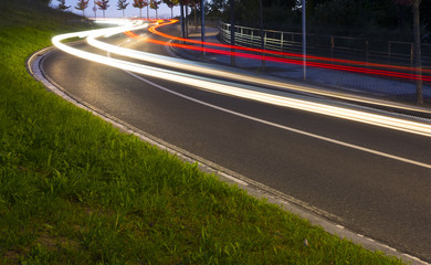 Traffic at night. Lights of the cars on the road to the tunnel.
