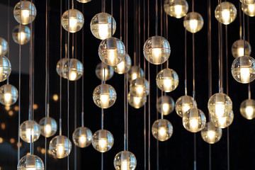  lighting balls on the chandelier in the lamplight,  light bulbs hanging from the ceiling, lamps on...