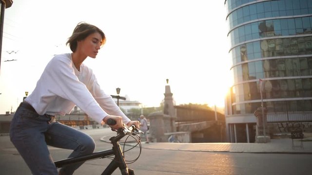 young female riding bike through the empty morning city