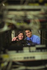 Technicians interacting with each other while analyzing server