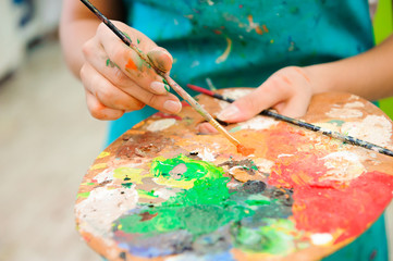 beautiful young girl draws a picture paints on art lesson