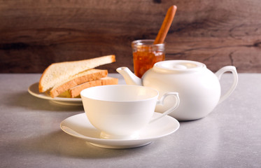White cup and tea pot