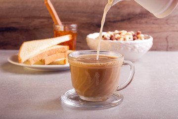 Pouring milk into coffee