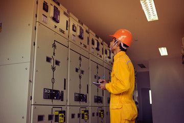 Engineers are checking the electrical system.with Orange filters