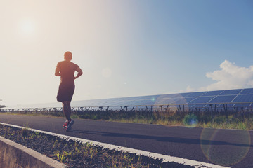 Man jogging in the evening.The background is a solar cell. Light