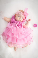 Portrait of a beautiful little baby girl in pink