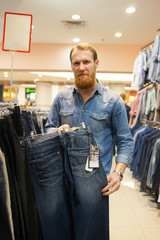 Man buying clothes in   shop.