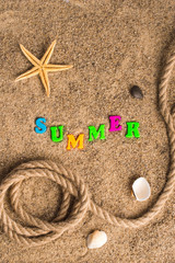 rope and a star on the sand with the word summer