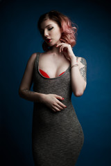 Fototapeta premium Portrait of a beautiful young girl with tattoo in the Studio