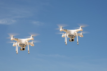 Image of two drones under blue sky