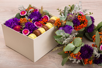 Seasonal autumn wreath and a hat box with flowers