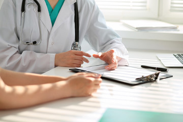 Doctor and patient are discussing something, just hands at the table