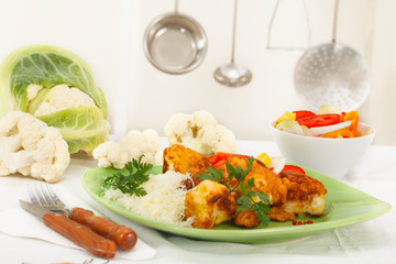 Domestic kitchen - breaded and fried cauliflower with grated cheese on green plate
