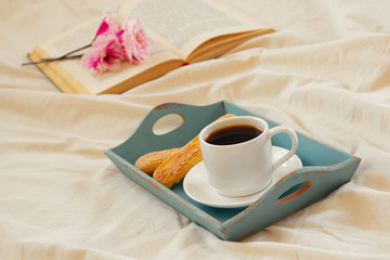 romantic breakfast in the bed and open book