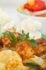 Breaded fried cauliflower with green parsley leaves