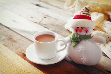 White cup with hot chocolate and snowman