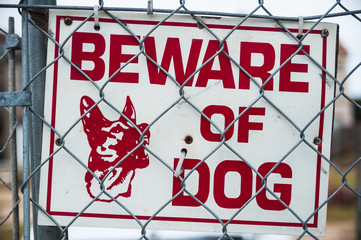  beware of guard dog sign on chain link fence