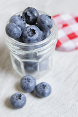 Fresh blueberries in a glass jar. Ripe blueberries. Jam and marmalade.