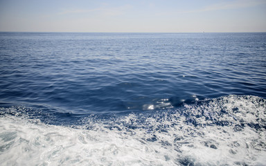 Fototapeta na wymiar Close-up of sea waves and white foam natural background.