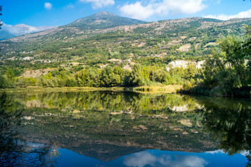 Fototapeta na wymiar mountains, sky and clouds reflected in the lake