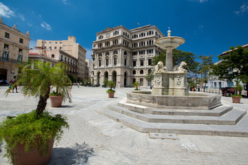 Fototapeta na wymiar Panoramic view to main square San Francisco in Havana at summer sunny day. Fountain with sculptures, architecture of ancient high buildings and small streets of capital.