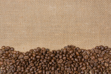 Coffee beans on gunny sack background