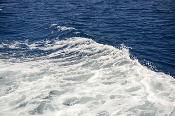 Naklejka na ściany i meble Deep blue sea with foam on the surface