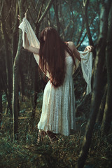 Woman alone in a strange dark forest