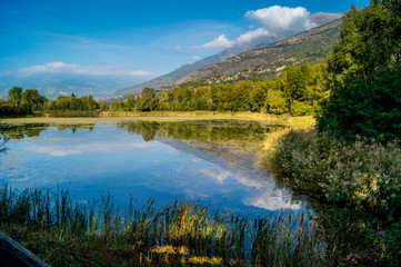 Fototapeta na wymiar mountains, sky and clouds reflected in the lake