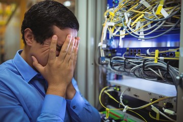 Technician getting stressed over server maintenance - obrazy, fototapety, plakaty