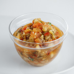 A dish of stewed vegetables on a white background