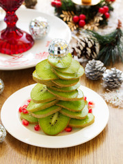 Salad of kiwi in the shape of a Christmas tree.