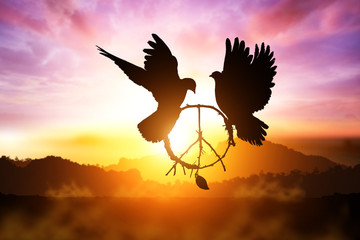 Plakat silhouette of pigeon dove holding branch in peace sign shape