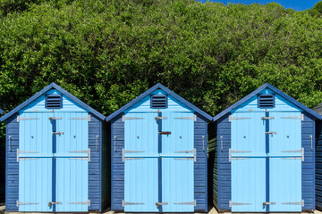 Blue painted beach huts in Swanage, Dorset, UK