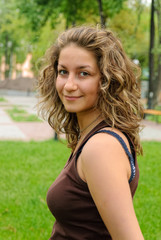 Fototapeta premium Young beautiful smiling woman at nature background