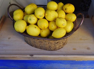 A basket of lemons on a windowsill