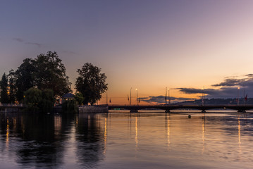 Bridge in Geneva reflecting in the lake at sunrise