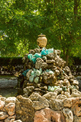 Fountain of the stones with a jug in summer Park