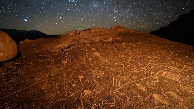 Astrophotography Time Lapse with pan motion of starry sky over Native American petroglyphs in Eastern Sierra, California -Long Shot-