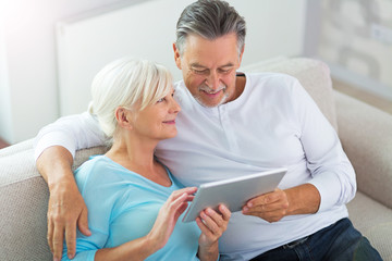 Senior couple using digital tablet
