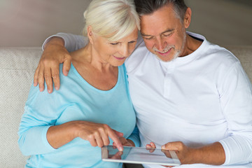 Senior couple using digital tablet
