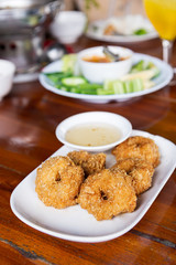 Deep-fried shrimp cakes, served on white dish and served with sw