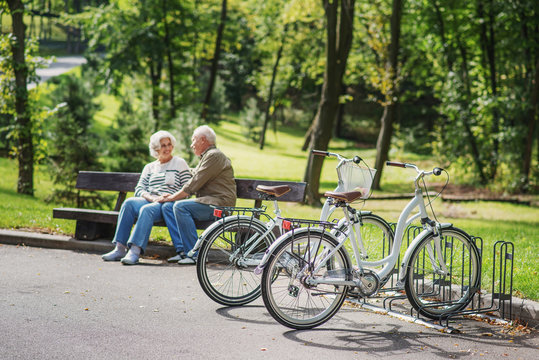 Mature man and woman resting after cycling