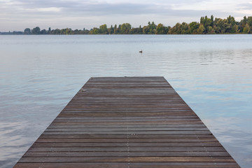 Wooden pier at lake in the early morning