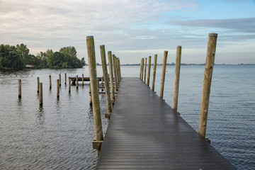 Fototapeta premium Wooden pier at Dutch lake in the early morning
