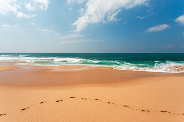 View of the ocean from the sandy beach. Footprints in the Sand.