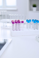 Research laboratory working space. Test tubes and tablet PC are lying at the table. Medical equipment. Blood test